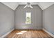 Charming bedroom with gray walls, paneled accents, hardwood floors, and a ceiling fan at 30 Mist Wood Ct, Pittsboro, NC 27312