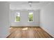 Light-filled bedroom with hardwood floors and large windows overlooking a green space at 30 Mist Wood Ct, Pittsboro, NC 27312