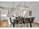 An airy dining room features modern lighting, leather chairs, and an open view into a stylish, white kitchen at 30 Mist Wood Ct, Pittsboro, NC 27312