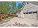 Home exterior featuring a driveway, garage, and landscaped yard at 30 Mist Wood Ct, Pittsboro, NC 27312