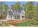 Stunning home with elegant architecture, showcasing manicured landscaping and a well-designed driveway at 30 Mist Wood Ct, Pittsboro, NC 27312
