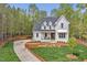 Charming home featuring a well-manicured lawn and a long, winding driveway leading up to the inviting front porch at 30 Mist Wood Ct, Pittsboro, NC 27312