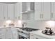 Well-equipped kitchen featuring stainless steel appliances, a sleek range hood, and ample counter space at 30 Mist Wood Ct, Pittsboro, NC 27312