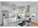 Modern kitchen boasts a spacious marble island, stainless steel appliances, and elegant white cabinetry at 30 Mist Wood Ct, Pittsboro, NC 27312