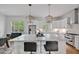 Expansive kitchen featuring a marble island with bar seating, stainless steel appliances, and custom cabinetry at 30 Mist Wood Ct, Pittsboro, NC 27312