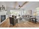 Sun-drenched living room showcases wood beams and an open layout with a cozy sunroom view at 30 Mist Wood Ct, Pittsboro, NC 27312