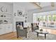 An inviting living room with fireplace and built-ins flows into a sunroom, creating a perfect space to relax and entertain at 30 Mist Wood Ct, Pittsboro, NC 27312