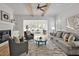 A sunlit living room features exposed beams, a fireplace, and a seamless transition to an inviting sunroom at 30 Mist Wood Ct, Pittsboro, NC 27312