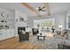 A cozy living room featuring a fireplace, built-in shelving, and an adjacent sunroom filled with natural light at 30 Mist Wood Ct, Pittsboro, NC 27312