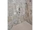 Elegant walk-in shower features marble tiling, a shower niche, and a handheld shower head at 30 Mist Wood Ct, Pittsboro, NC 27312