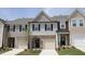 Charming townhome exterior featuring stone accents, siding, and attached garages at 3007 Cypress Lagoon Ct, Durham, NC 27703