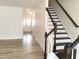Inviting foyer with staircase and wood-look flooring at 3007 Cypress Lagoon Ct, Durham, NC 27703