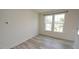 Bright living room featuring wood flooring and natural light from large windows at 3007 Cypress Lagoon Ct, Durham, NC 27703
