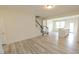 Bright and spacious living area with hardwood floors and staircase at 3007 Cypress Lagoon Ct, Durham, NC 27703