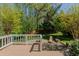 A wood deck overlooks a backyard with a firepit at 308 Grove Hall Ln, Mebane, NC 27302