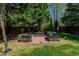 The backyard showcases raised brick planters and a well-maintained lawn, creating a serene outdoor space at 308 Grove Hall Ln, Mebane, NC 27302
