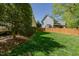 The backyard shows a green lawn with a newly installed wooden fence that provides privacy and security at 308 Grove Hall Ln, Mebane, NC 27302