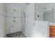 Bright bathroom features a spacious tiled shower with multiple shower heads and tile accents at 308 Grove Hall Ln, Mebane, NC 27302