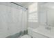 Cozy bathroom with a shower with a curtain, a toilet, and a sink next to a window at 308 Grove Hall Ln, Mebane, NC 27302
