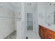 Bright bathroom features a spacious tiled shower, neutral walls, and vanity with cabinet at 308 Grove Hall Ln, Mebane, NC 27302