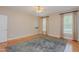 Sunny bedroom with hardwood floors, ceiling fan, and neutral decor at 308 Grove Hall Ln, Mebane, NC 27302