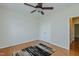Bedroom featuring a ceiling fan, wood flooring, and a double-door closet at 308 Grove Hall Ln, Mebane, NC 27302