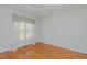 A cozy bedroom features hardwood floors and a window with blue and yellow striped valance at 308 Grove Hall Ln, Mebane, NC 27302