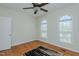 Bedroom with wood floors, ceiling fan, and arched windows providing natural light at 308 Grove Hall Ln, Mebane, NC 27302