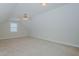 Large carpeted bonus room features neutral walls, a ceiling fan, and a bright window at 308 Grove Hall Ln, Mebane, NC 27302