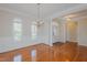 Elegant dining room with hardwood floors, classic wainscoting, a chandelier and arched windows at 308 Grove Hall Ln, Mebane, NC 27302