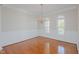 Elegant dining room with hardwood floors, classic wainscoting, a chandelier and arched windows at 308 Grove Hall Ln, Mebane, NC 27302