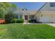 Charming home featuring a red front door, attached garages, well-manicured lawn and inviting front porch seating area at 308 Grove Hall Ln, Mebane, NC 27302