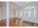 Inviting foyer leads to an elegant dining room with hardwood floors and classic wainscoting at 308 Grove Hall Ln, Mebane, NC 27302