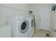 Functional laundry room with modern appliances and convenient shelving at 308 Grove Hall Ln, Mebane, NC 27302