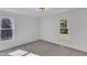 Bedroom featuring soft carpeting, two windows offering natural light, and white walls at 3100 Greenville Loop Rd, Wake Forest, NC 27587