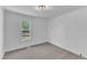 Neutral bedroom with one window, neutral carpet, white walls, and natural light at 3100 Greenville Loop Rd, Wake Forest, NC 27587