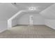 Large bonus room featuring vaulted ceilings, soft carpeting, and modern lighting at 3100 Greenville Loop Rd, Wake Forest, NC 27587