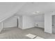 Large bonus room featuring vaulted ceilings, soft carpeting, and modern lighting at 3100 Greenville Loop Rd, Wake Forest, NC 27587