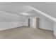 Large bonus room featuring vaulted ceilings, soft carpeting, and modern lighting at 3100 Greenville Loop Rd, Wake Forest, NC 27587