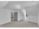 Large bonus room featuring vaulted ceilings, soft carpeting, modern lighting, and natural lighting at 3100 Greenville Loop Rd, Wake Forest, NC 27587