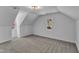 Bright bonus room featuring vaulted ceilings, soft carpeting, and natural lighting at 3100 Greenville Loop Rd, Wake Forest, NC 27587