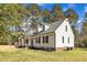 Beautifully designed exterior showcasing dormer windows, black shutters, and manicured landscaping at 3100 Greenville Loop Rd, Wake Forest, NC 27587