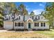 Attractive exterior featuring a blue front door, dormer windows, and well-maintained landscaping at 3100 Greenville Loop Rd, Wake Forest, NC 27587