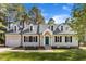 Charming home boasts a teal door, dormer windows, black shutters and a well-manicured lawn at 3100 Greenville Loop Rd, Wake Forest, NC 27587