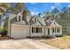 Charming two-story home with a landscaped yard and an attached garage at 3100 Greenville Loop Rd, Wake Forest, NC 27587