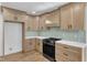 Bright kitchen features shaker cabinets, white counters, stylish tile backsplash, and stainless steel oven at 3100 Greenville Loop Rd, Wake Forest, NC 27587