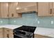 Close up on kitchen features with shaker cabinets, white counters, stylish tile backsplash, and stainless steel oven at 3100 Greenville Loop Rd, Wake Forest, NC 27587