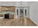 Sunlit kitchen with shaker cabinets, white counters, stainless steel oven and backyard access at 3100 Greenville Loop Rd, Wake Forest, NC 27587
