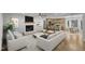 Inviting living room with fireplace opens to a modern kitchen with seating at the breakfast bar at 3100 Greenville Loop Rd, Wake Forest, NC 27587