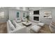 Bright living room with hardwood floors, ceiling fan, modern furniture, fireplace, and views to the outside at 3100 Greenville Loop Rd, Wake Forest, NC 27587